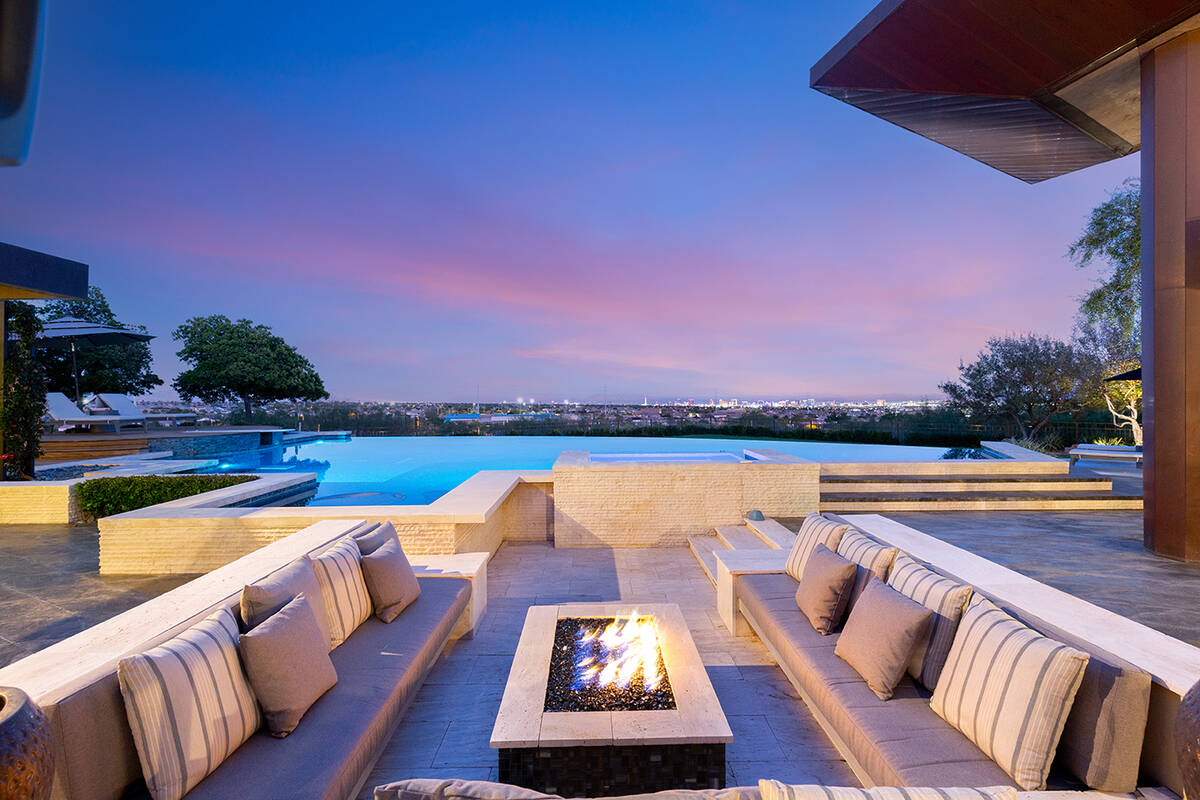 The home in The Ridges has a pool with a seating area and fire feature. (IS Luxury)